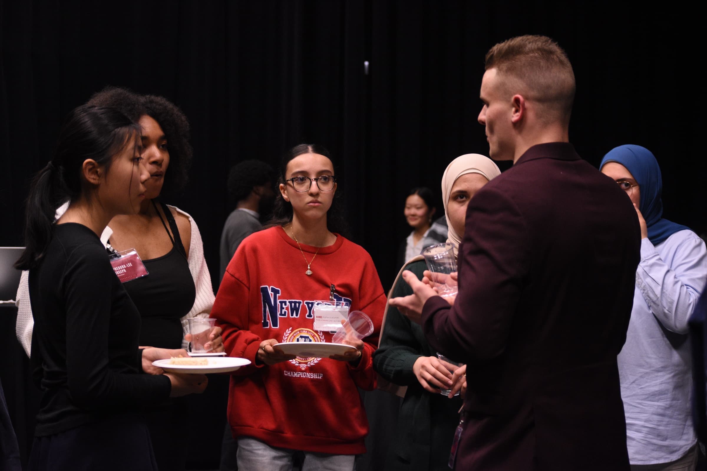 Nate Roy talking with students after an event