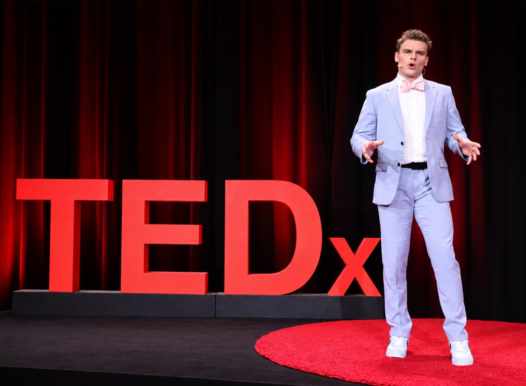 Nate Roy speaking on the TEDx stage