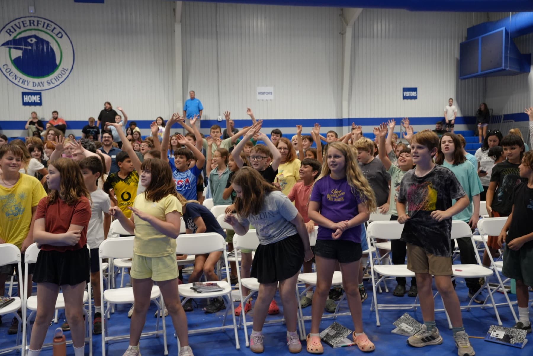 A full gym of students on their feet at a Cortex Flex event