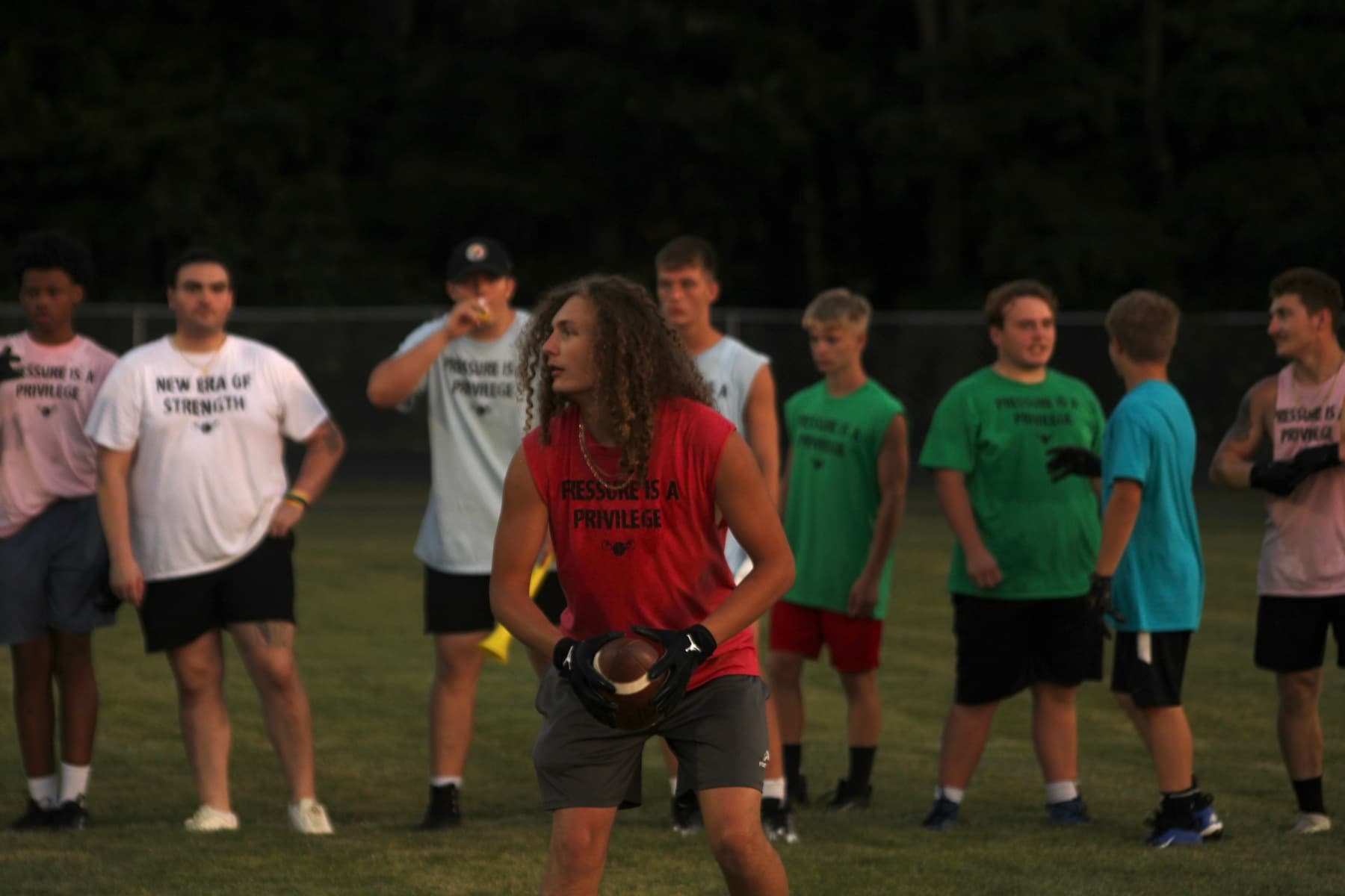 Athletes lined up for a drill at an evening session