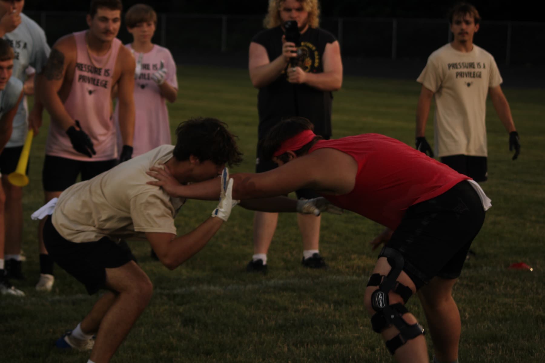 Two athletes in a contact drill at an evening session