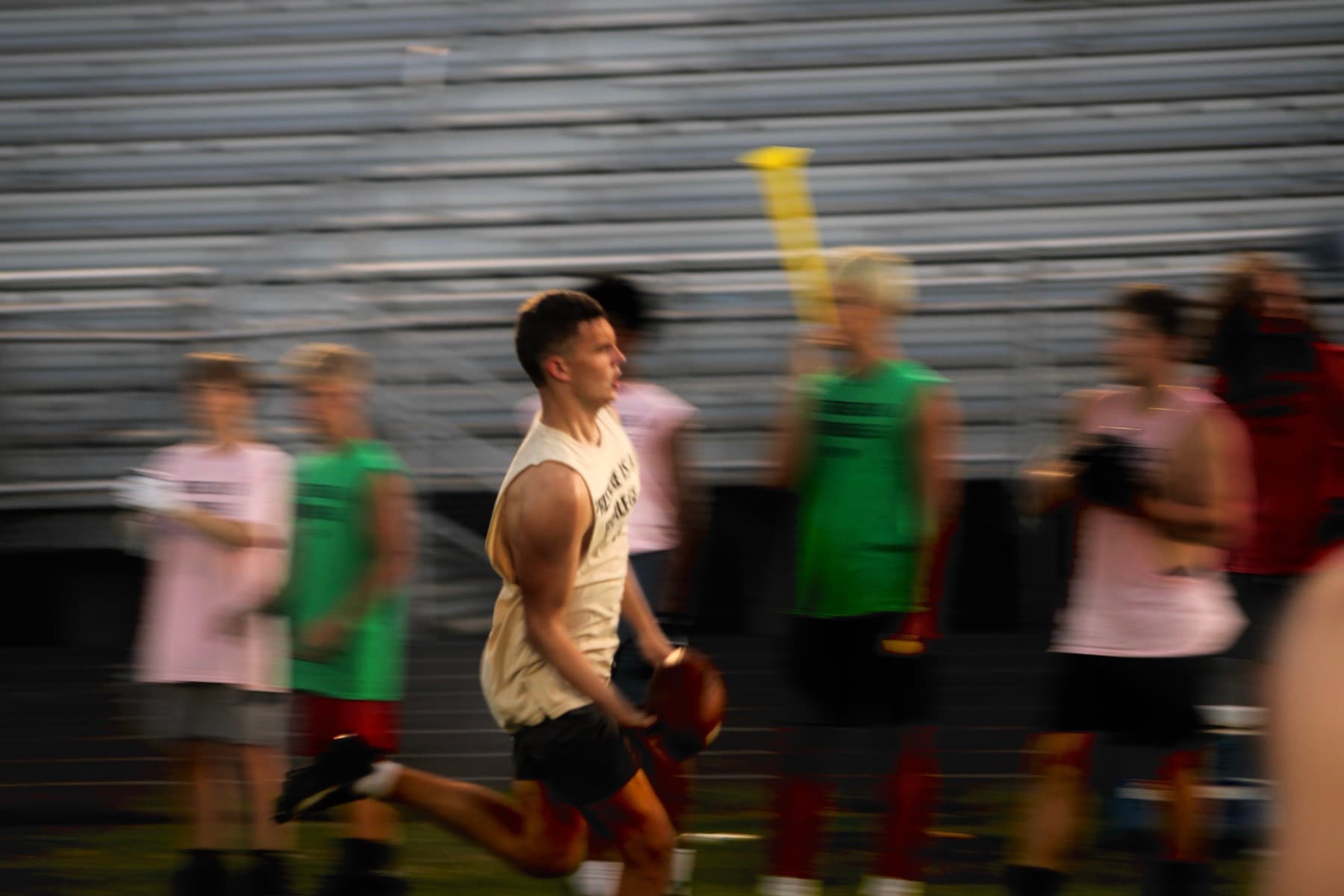 An athlete exploding out of a drill at an evening session